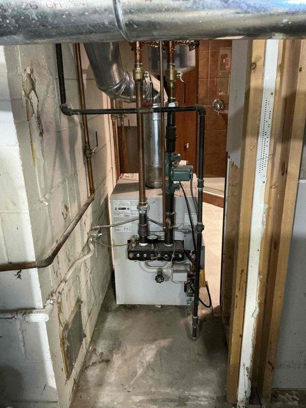 Provided comprehensive estimate for replacement of 15-year-old residential hot water boiler system in basement mechanical room. Assessed existing hydronic heating equipment, associated copper piping, expansion tank, and control components to determine scope of work and equipment specifications for complete system replacement.