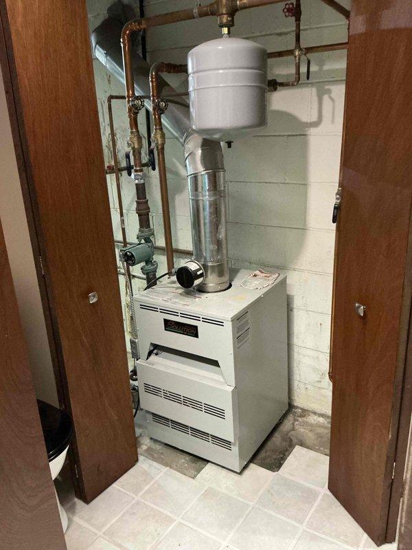 Provided comprehensive estimate for replacement of 15-year-old residential hot water boiler system in basement mechanical room. Assessed existing hydronic heating equipment, associated copper piping, expansion tank, and control components to determine scope of work and equipment specifications for complete system replacement.