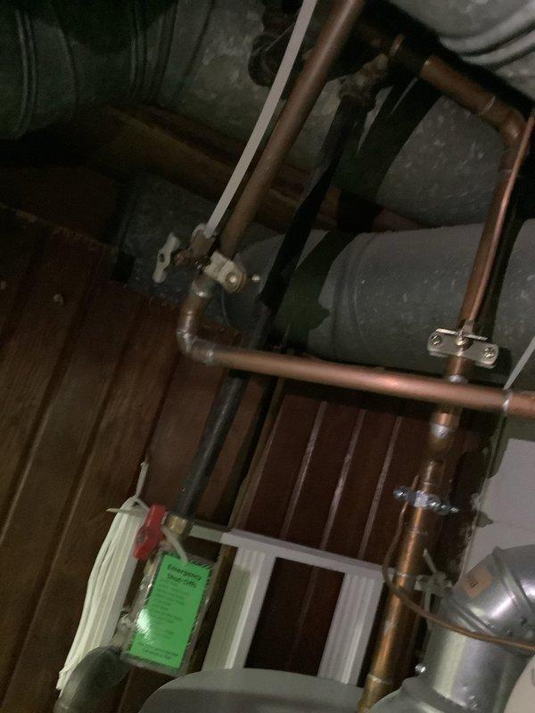 Responded to emergency water leak affecting hot water system. Upon arrival, confirmed hot water supply had been shut off as a precautionary measure to prevent further water damage. Conducted thorough inspection of copper piping loop configuration, expansion tank, and associated plumbing components in utility area. Identified source of leak in hot water distribution system. Assessed solder joints and fittings throughout the copper pipe assembly for integrity. Documented existing mechanical system installation including expansion tank, pressure vessel, and interconnected piping for service records. System evaluated and leak addressed to restore safe operation of hot water supply.