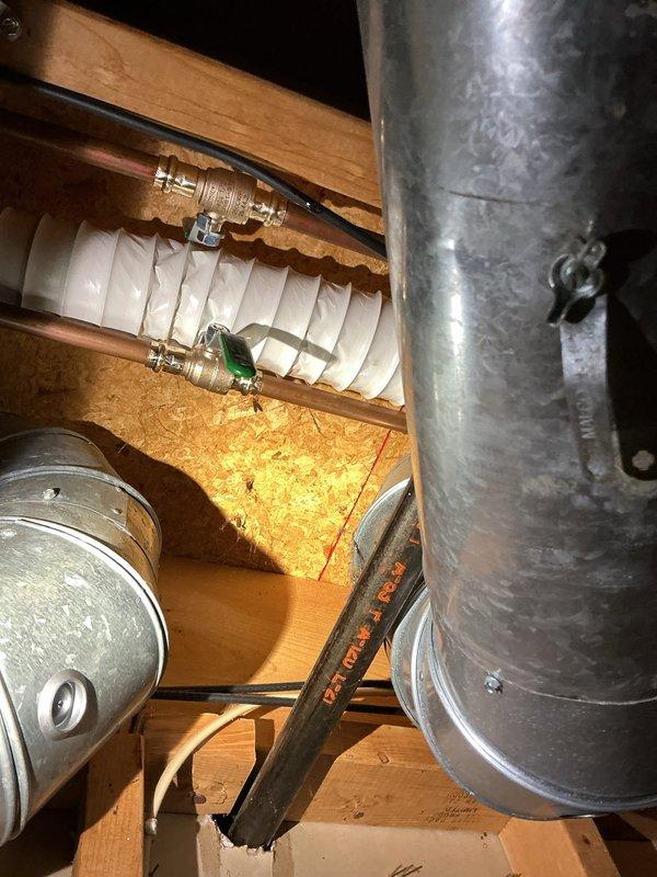 Responded to emergency water leak in downstairs bathroom of 28-year-old home. Upon arrival, main water supply had been shut off by homeowner due to active leak that began the previous evening. Identified source of leak at shower valve assembly behind wall-mounted chrome fixtures. Accessed plumbing through basement/crawlspace area beneath bathroom to assess extent of damage and confirm leak origin. Repaired failed connection at shower diverter valve, replaced worn rubber washers and seals, and tightened compression fittings on supply lines. Verified all flexible supply hoses and brass fittings were properly secured with metal clamps. Restored water supply to home and tested shower valve operation under full pressure to confirm leak was eliminated. No water damage observed to surrounding framing or subfloor materials.