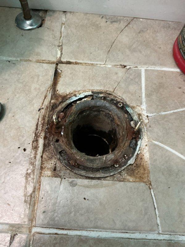 Responded to service call for leaking toilet at base. Upon inspection, confirmed active water seepage around toilet base indicating compromised wax ring seal. Removed toilet from floor flange, discarded deteriorated wax ring and corroded closet bolts. Cleaned flange surface and toilet base thoroughly to ensure proper seal. Installed new wax ring and new closet bolts with washers. Reset toilet onto flange, ensuring proper alignment and compression of wax seal. Tightened bolts evenly to manufacturer specifications to prevent cracking while securing fixture. Reconnected water supply line and tested for leaks. Cycled toilet multiple times and verified no water seepage at base. Left work area clean and operational.