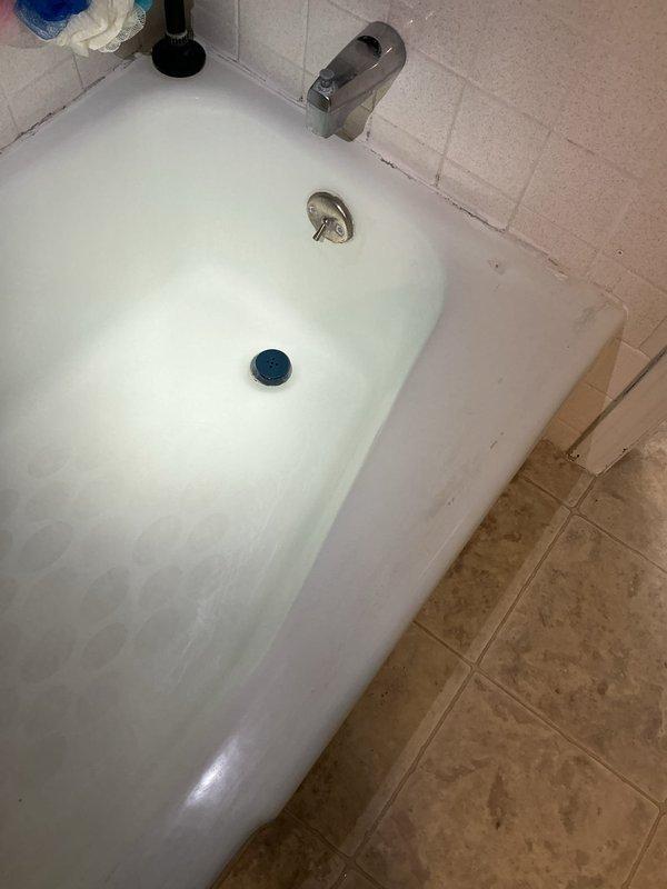 Responded to service call for bathtub drainage and shower leak issues. Upon inspection, identified faulty tub stopper assembly causing water leakage during bathing, water infiltration into electrical panel access behind shower wall during shower use, and malfunctioning overflow drain requiring sealing. Assessed bathtub drain mechanism with chrome cover and stopper, examined tile surround and spout installation, and inspected accessible plumbing infrastructure including copper supply lines and PVC drainage system showing age-related corrosion. Documented existing conditions of fixtures, drainage components, and compromised areas where water penetration was occurring near electrical panel access point.