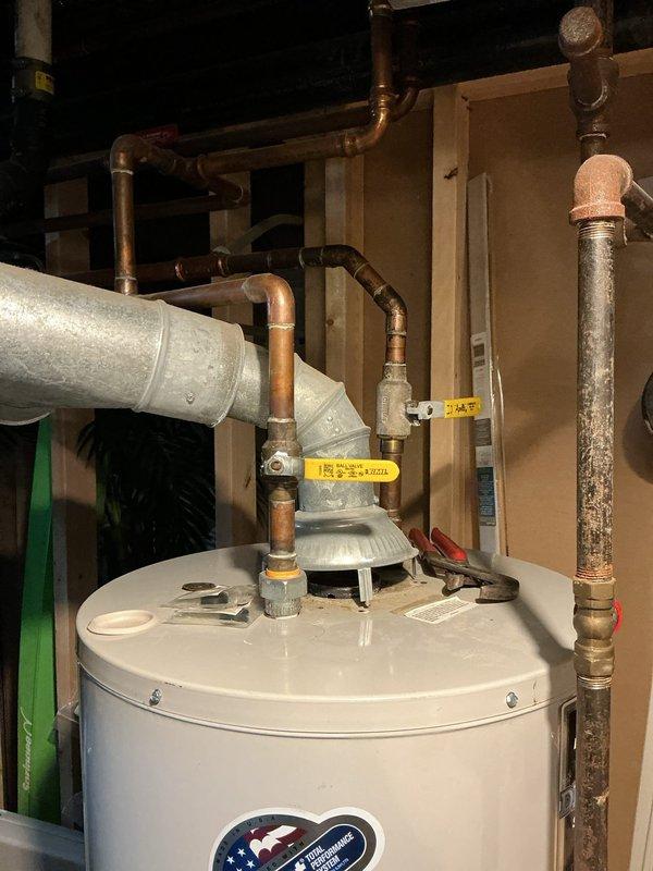 Responded to service call for leaking water heater with no hot water availability. Upon inspection, identified active leak at water heater tank requiring immediate attention. Documented existing plumbing configuration including copper supply lines, pressure relief valve assembly, and associated piping connections. Assessed overall condition of tanked water heater system and provided customer with findings and recommended solutions for restoration of hot water service.