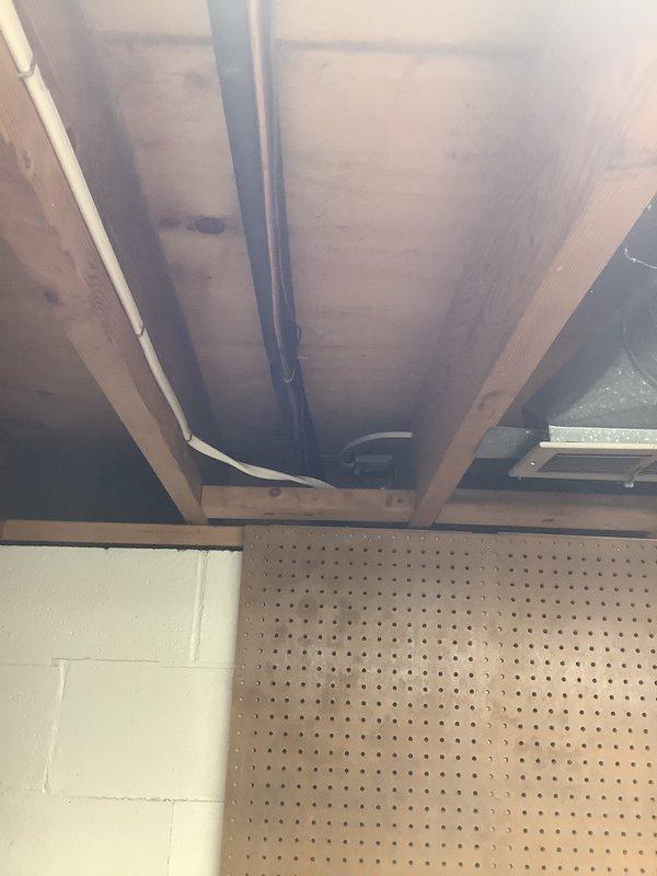 Provided estimate for replacement of 27-year-old air conditioning system with new single-stage 3.5-ton unit at single-family residence. Assessed existing HVAC installation located in basement utility area, including furnace/air handler unit with associated condensate drain lines and refrigerant piping. Replacement quote prepared in anticipation of upcoming foundation work requiring temporary removal of equipment, with full system replacement recommended due to age of existing unit.