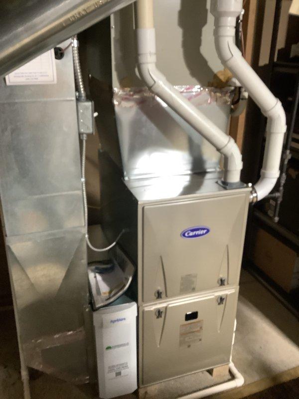 Completed on-site assessment for HVAC system replacement estimate. Evaluated existing Carrier furnace installation in basement utility area, including sheet metal ductwork plenum, PVC condensate drainage system, and associated components. Inspected exterior utility connections including refrigerant line sets with insulation wraps, electrical service panel, and ground-level HVAC piping infrastructure. Documented current system configuration and photographed equipment conditions to provide comprehensive replacement quote for complete heating and cooling system upgrade.