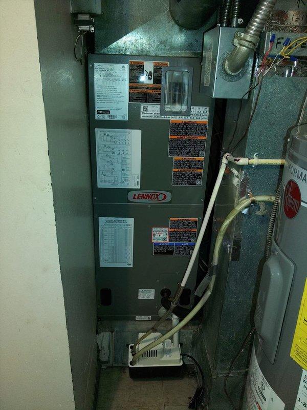 Completed full HVAC system installation including Lennox air handler with heat strips, heat pump condenser unit, and condensate pump in residential utility space. Removed existing humidifier per specifications, installed new refrigerant line set with proper insulation and brass service valves, configured condensate drainage with PVC trap assembly, and verified all electrical connections and system startup per manufacturer requirements.