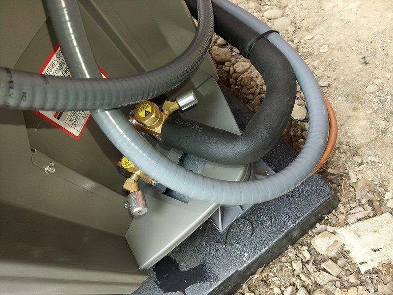 Completed full HVAC system installation including Lennox air handler with heat strips, heat pump condenser unit, and condensate pump in residential utility space. Removed existing humidifier per specifications, installed new refrigerant line set with proper insulation and brass service valves, configured condensate drainage with PVC trap assembly, and verified all electrical connections and system startup per manufacturer requirements.
