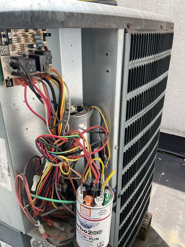 Responded to no cooling complaint on 14-year-old rooftop air conditioning unit. Accessed unit via ladder and crawlspace. Upon inspection, found failed motor-run capacitor preventing compressor operation. Removed access panel and inspected electrical components. Replaced defective Amrad Turbo 200 capacitor with new unit, reconnected all electrical terminals, and verified proper wire connections. Tested system operation and confirmed compressor startup and normal cooling function restored. Secured access panel and left unit operational.