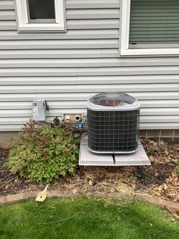 Completed full HVAC system installation including a 93% efficiency furnace and air conditioning unit. The furnace was installed in the basement utility area with proper venting and condensate drainage using white PVC piping, while the outdoor condensing unit was positioned on a concrete pad against the home's foundation with appropriate electrical disconnect and service connections. All equipment was properly wired, tested for operation, and landscaping around the exterior unit was preserved during installation.