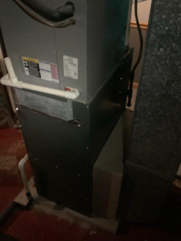 Completed full HVAC system installation including a 93% efficiency furnace and air conditioning unit. The furnace was installed in the basement utility area with proper venting and condensate drainage using white PVC piping, while the outdoor condensing unit was positioned on a concrete pad against the home's foundation with appropriate electrical disconnect and service connections. All equipment was properly wired, tested for operation, and landscaping around the exterior unit was preserved during installation.