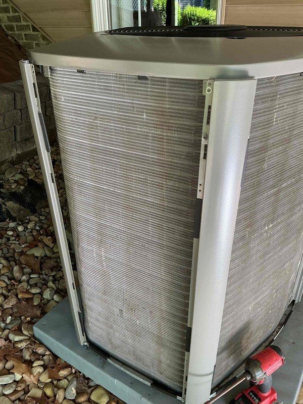 Completed routine maintenance on a two-year-old residential air conditioning system. Performed comprehensive inspection of outdoor condenser unit, noting accumulated dust and debris between coil fins. Cleaned condenser coils to restore proper airflow and heat transfer efficiency. Accessed indoor evaporator coil assembly and inspected refrigerant line connections and insulation integrity. All refrigerant lines showed proper insulation with no visible damage. Verified system components operating within normal parameters. Unit returned to service in good working condition.