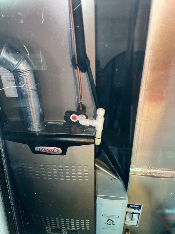 Completed comprehensive AC tune-up on 5-year-old Lennox cooling system. Performed full preventive maintenance including inspection of indoor air handler and outdoor condenser unit, checked refrigerant levels and pressures, cleaned condenser coils, verified electrical connections, tested thermostat operation, and inspected all ductwork connections. System operating within manufacturer specifications with no issues identified; all components functioning properly and unit ready for cooling season.