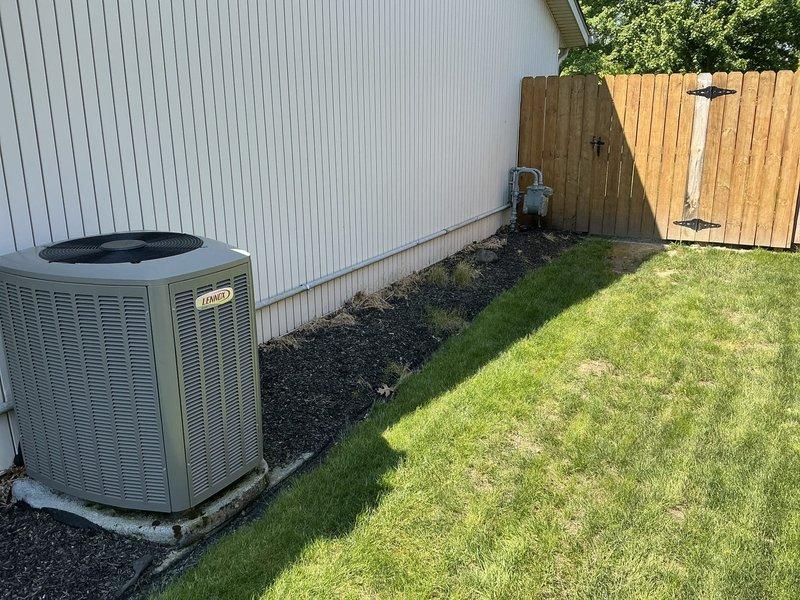 Conducted on-site evaluation for whole home generator installation at residential property. Assessed existing electrical infrastructure, including current HVAC system placement and electrical service panel location. Documented installation area in side yard, noting existing Lennox outdoor unit positioning, available concrete pad space, and proximity to main electrical service. Evaluated clearance requirements, access for gas line connection, and optimal placement for generator unit to meet code compliance and manufacturer specifications. Photographed site conditions including foundation landscaping, utility routing paths, and available installation space to prepare comprehensive electrical estimate for standby generator system.