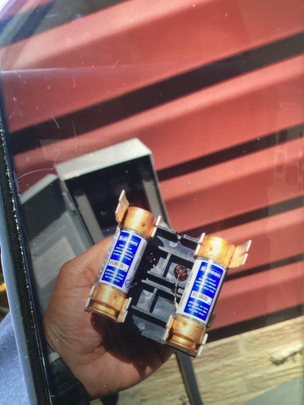 Responded to no-cooling service call following previous day's A/C installation. Upon inspection, discovered blown fuses in the outdoor unit disconnect switch. Removed and replaced faulty fuses in the fuse block, restored power to the system, and verified proper operation of the air conditioning unit.