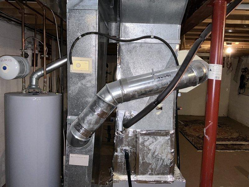 Conducted comprehensive assessment of existing HVAC system for replacement estimate, including 3-year-old furnace and 30-year-old air conditioning unit. Evaluated current equipment condition, ductwork configuration, and mechanical room layout to determine optimal replacement specifications. Documented existing system components including air handler, metallic ductwork with humidifier attachment, and overall installation accessibility for future equipment upgrade planning.