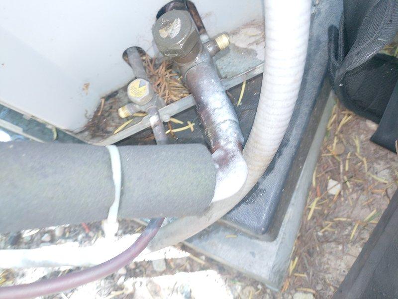 Responded to service call for one-year-old air conditioning system not cooling properly. Upon inspection, utilized thermal imaging equipment to diagnose system performance and identified refrigerant line issues in the attic installation area. Inspected insulated copper refrigerant lines, verified proper connections at brass valve fittings, and assessed system components for temperature differentials to determine root cause of cooling failure.