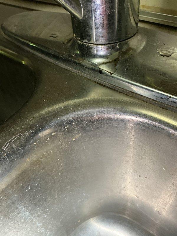 Responded to multiple plumbing issues in a 1964 single-family residence. Addressed leaking shower head and possible mixer/diverter malfunction in main bathroom, which exhibited significant rust staining on surrounding wall surfaces and corrosion on mounting hardware. Inspected and serviced Moen kitchen sink faucet requiring seal replacement, noting typical wear patterns on stainless steel basin. Evaluated basement shower handles for seal replacement or adjustment to eliminate leaks. Documented all fixtures with photographs for service records. All work completed without access restrictions or safety concerns.