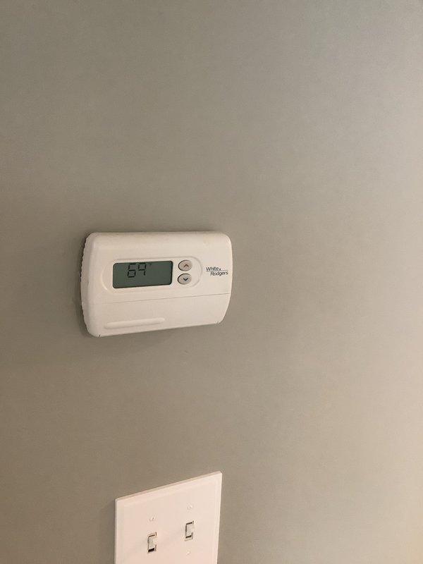 Conducted on-site evaluation for complete HVAC system replacement. Assessed existing heating and cooling equipment, including current thermostat (White-Rodgers digital unit displaying 69°F) and attic-mounted air handler with associated ductwork and wiring connections. Documented current system configuration through photographs showing thermostat location, electrical controls, and attic installation with exposed framework, control box, refrigerant lines, and wire terminations. Prepared comprehensive estimate for replacing entire HVAC heat and cool system based on existing conditions and customer requirements.