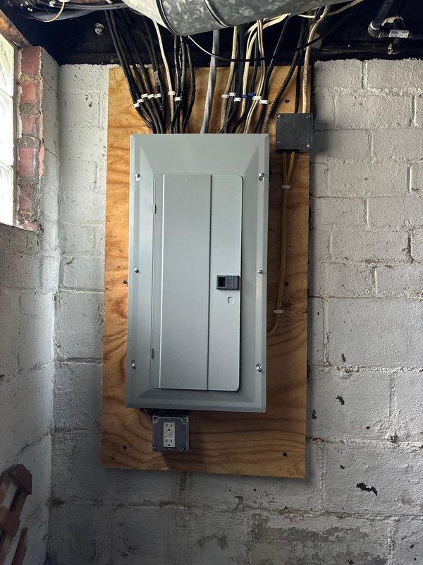 Completed 100-ampere electrical service upgrade including installation of new main breaker panel with proper circuit identification and labeling. Updated grounding system to meet current code requirements and installed exterior disconnect switch in compliance with 2023 National Electrical Code Article 230.85. All conductors properly terminated, panel mounted on plywood backing in utility space, and multiple branch circuits organized with appropriate overcurrent protection devices.