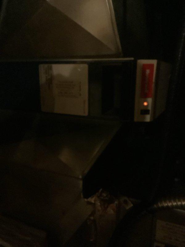 Responded to service call for 15-year-old geothermal system reported as not working. Upon inspection, verified the primary geothermal unit was operational; the issue was isolated to the air purification system's indicator light not functioning. Examined the Honeywell air purification control unit mounted in the mechanical space and confirmed the system power status through visual inspection of equipment components and connections.