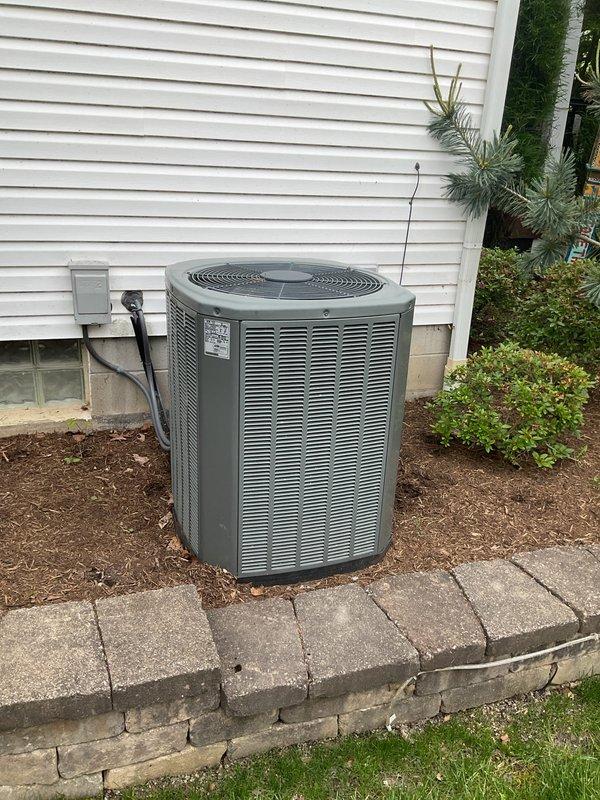 Responded to service call for non-operational AC condenser affecting entire home on 14-year-old system. Upon inspection, identified failed dual-run capacitor with visible rust and corrosion on mounting bracket and terminals. Replaced defective capacitor with new unit, verified proper electrical connections, and tested system operation. Unit restored to full functionality with condenser fan and compressor operating within normal parameters.