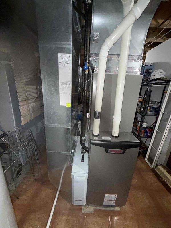 Performed comprehensive spring maintenance inspection on 1.5-year-old residential air conditioning system. Conducted visual assessment of evaporator coil assembly, noting dust and dirt accumulation on heat exchanger fins requiring attention. Inspected air handler unit, condensate drainage system with PVC piping, and associated ductwork connections to verify proper system operation and readiness for cooling season.