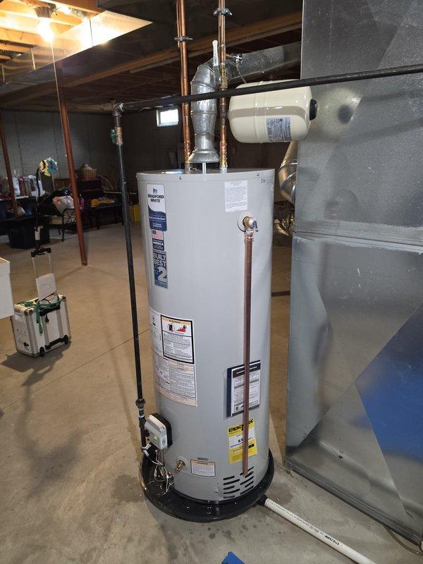 Removed existing water heater and installed new Bradford White 8-year warranty unit with complete system integration. Replaced thermal expansion tank to ensure proper pressure regulation and system safety. All existing plumbing connections, gas lines, temperature and pressure relief valve, and copper piping were verified to meet current code requirements upon completion of installation.