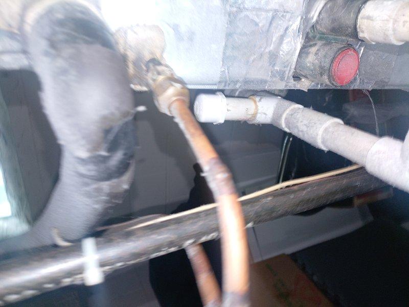 Responded to no cooling complaint on 31-year-old residential air conditioning system installed in the 1990s. Upon inspection, found aging HVAC equipment located in attic space with original copper refrigerant lines, condensate drainage system, and air handler unit showing significant age-related wear. Documented existing system configuration including insulated refrigerant linesets, PVC condensate piping, and ductwork connections. Given the advanced age of the equipment beyond its expected service life, advised customer that system has reached end of useful operation and replacement should be considered for reliable cooling performance.