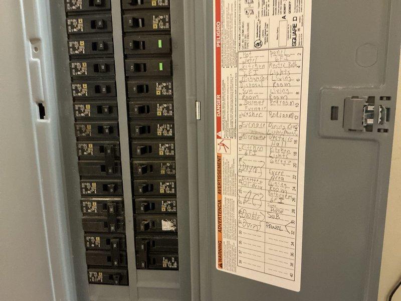 Completed electrical assessment for standby generator installation. Documented existing electrical service configuration including main breaker panel with current circuit directory and secondary distribution panel. Photographed panel locations, available installation space near existing electrical infrastructure, and exposed wall framing in preparation area. Confirmed existing electrical system specifications and identified optimal connection points for generator transfer switch integration with current service panels.