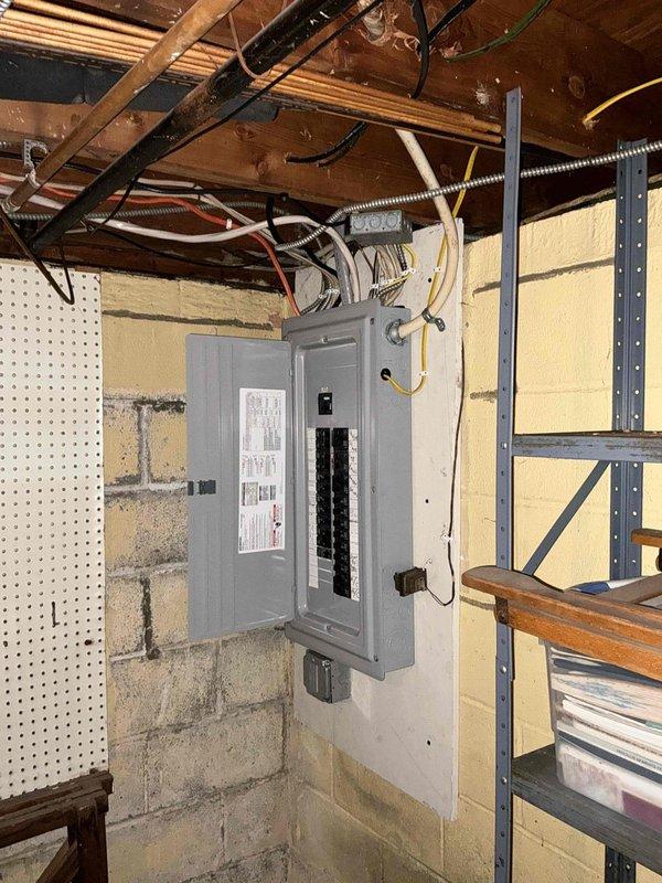 Conducted on-site assessment for mini split installation in lower level bedroom. Evaluated electrical panel capacity and circuit availability in basement utility area, documented existing infrastructure including panel location and wire routing. Assessed bedroom layout and identified optimal mounting location for indoor air handler unit on wall above storage area, ensuring proper clearance and airflow distribution for effective cooling coverage.
