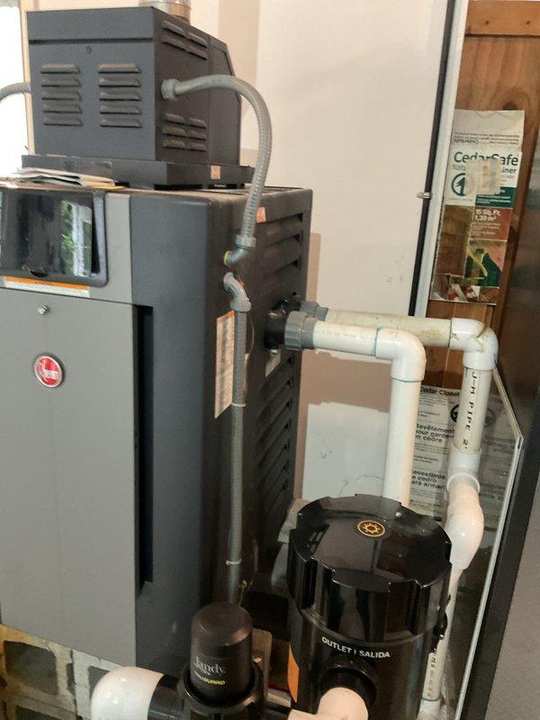 Responded to service call for 9-year-old Rheem heat pump system with reported leaking concerns. Upon inspection, discovered significant rust and corrosion on internal burner assembly and gas manifold components, with visible rust staining on interior metal surfaces beneath the affected areas. Documented existing condition through photographs showing deteriorated cylindrical burner component with brass valve stems and orange-brown rust discoloration throughout the combustion chamber area. Advised customer of findings and potential need for follow-up service to address corrosion issues and prevent further system degradation.