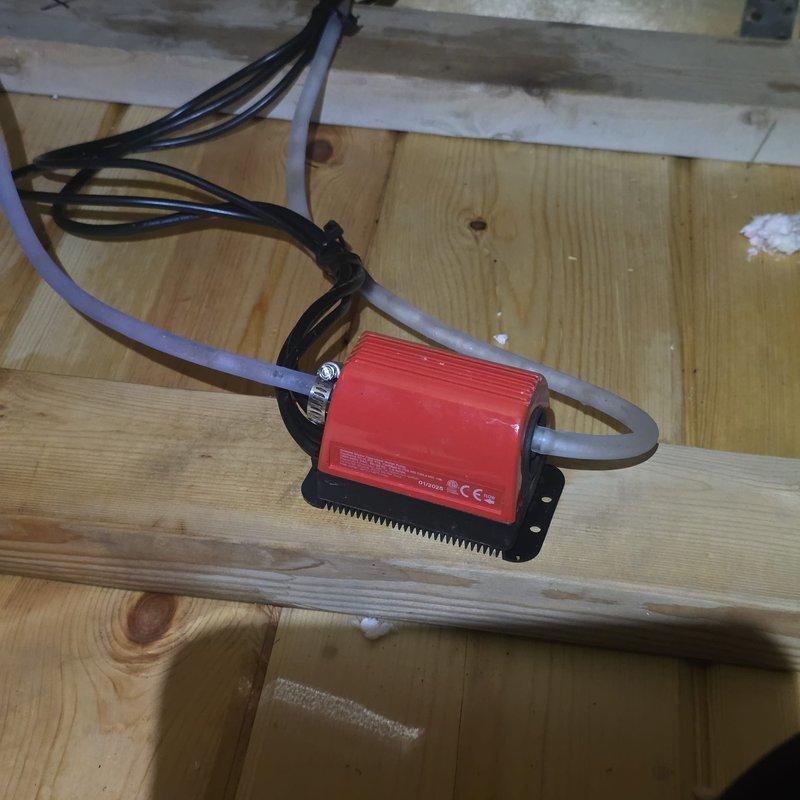 Responded to water leak complaint on recently installed mini-split system with water dripping through ceiling. Accessed attic space and inspected condensate drain line installation on mini-split air handler. Found improper drain line pitch causing water to back up and overflow from drain pan, resulting in ceiling leak below unit.