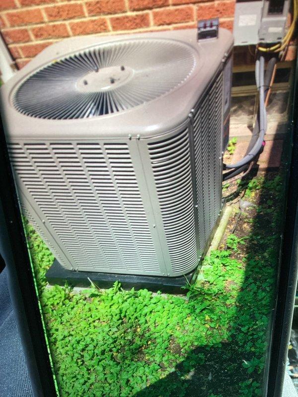 # HVAC Service Report

Responded to no-cooling complaint on newly installed air conditioning system. Upon arrival, performed visual inspection of both indoor and outdoor equipment. Examined indoor unit components including capacitor, motor assembly, and electrical connections. All wire connections were properly secured and labeled per manufacturer specifications. Inspected outdoor condenser unit positioned against building exterior, noting proper clearances and mounting. Verified electrical disconnect and conduit installation. Unit appeared to be correctly installed with appropriate airflow through louvers and fan grille. Diagnostic testing revealed system operational issue related to new installation startup. Addressed cooling deficiency and restored proper system operation. Equipment now functioning within normal parameters.