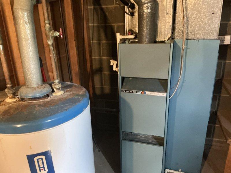 Performed HVAC estimate for complete furnace and air conditioning system replacement in residential basement utility area. Assessed existing aging heating center and evaluated installation requirements for new equipment. Documented current mechanical room configuration including water heater placement, structural support columns, plumbing infrastructure, and available clearances for new system installation. Coordinated scheduling requirements and provided comprehensive replacement quote for dual-system installation.