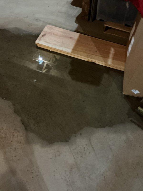 Responded to plumbing overflow emergency in basement of 40-year-old residential property. Upon arrival, found significant standing water accumulation on concrete basement floor affecting storage area and workbench space. Conducted thorough inspection to identify source of water intrusion and assessed extent of overflow damage. Documented conditions with photographic evidence showing water pooling and affected furnishings. Addressed plumbing issue causing overflow, restored proper drainage function, and provided recommendations for water removal and prevention of future incidents.