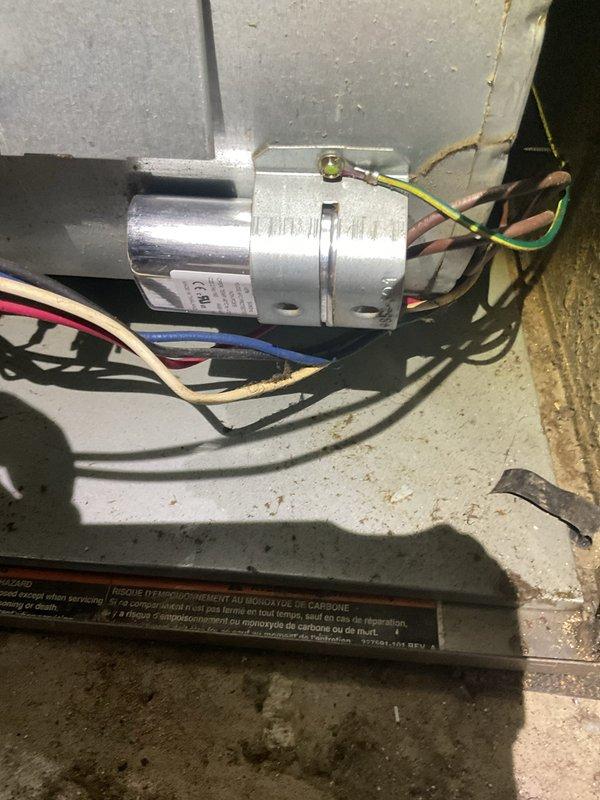 Responded to service call for non-operational air conditioning system on approximately 18-month-old unit. Upon inspection, diagnosed failed run capacitor in the condensing unit's electrical system. Replaced defective capacitor with manufacturer-specified component, restored proper electrical connections, and verified all wire terminations were secure. Tested system operation and confirmed air conditioner returned to normal cooling function with proper amperage draw and cycle timing.