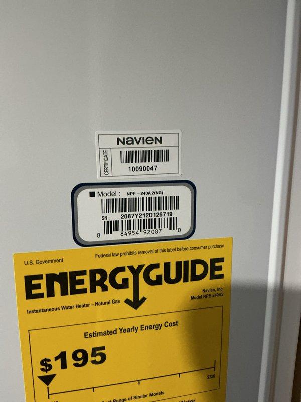 Responded to service call for Navien NPE-240A2 tankless water heater not producing adequate hot water throughout the system. Performed diagnostic evaluation of the unit, inspected all water and gas connections, verified proper venting configuration, and assessed digital control panel operation. Confirmed proper installation of hot and cold PEX supply lines and exhaust venting system, documented unit specifications and current operational status through photographs for service records.