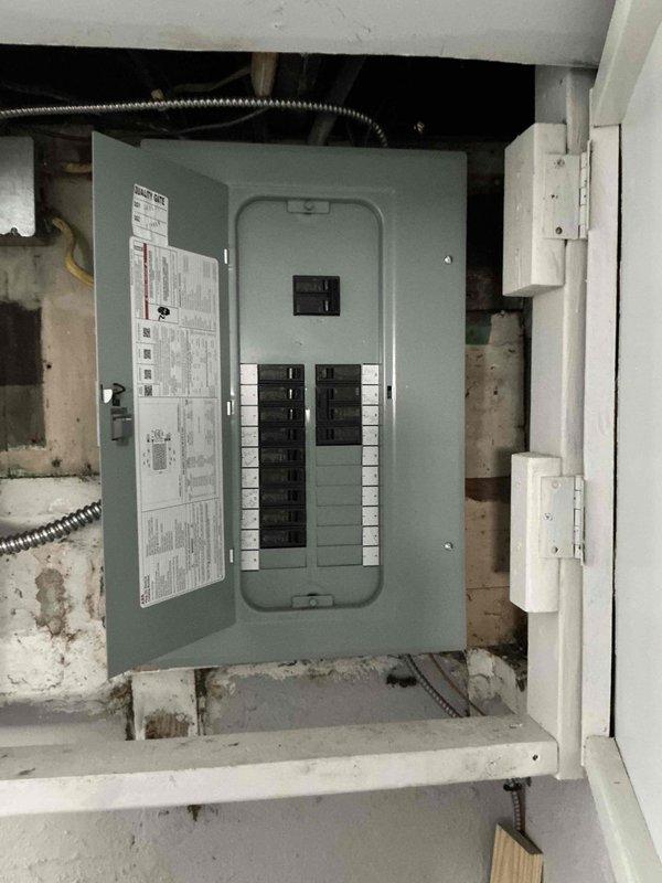 Conducted on-site assessment for air conditioning system installation to complement recently installed furnace and ductwork. Evaluated existing HVAC air handler unit located in basement utility area, inspected electrical panel capacity for AC condenser requirements, and documented current equipment configuration. Noted existing moisture issues on floor near equipment and deteriorating wall conditions that may require attention during installation to ensure proper system performance and longevity.