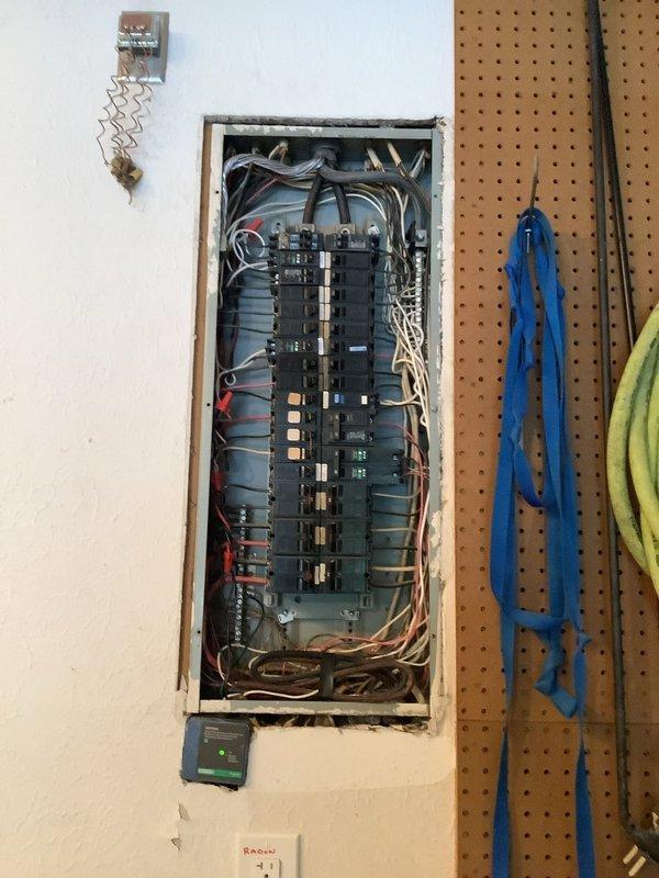 Performed electrical panel inspection and assessment. Documented existing electrical service installation including exterior meter box with visible internal components and weathered disconnect box, as well as interior main breaker panel with multiple circuit breakers and wire routing. Customer requested quote for new breaker box replacement due to condition of existing equipment. Captured photographic documentation of current panel configuration and exterior utility connections for estimate preparation.