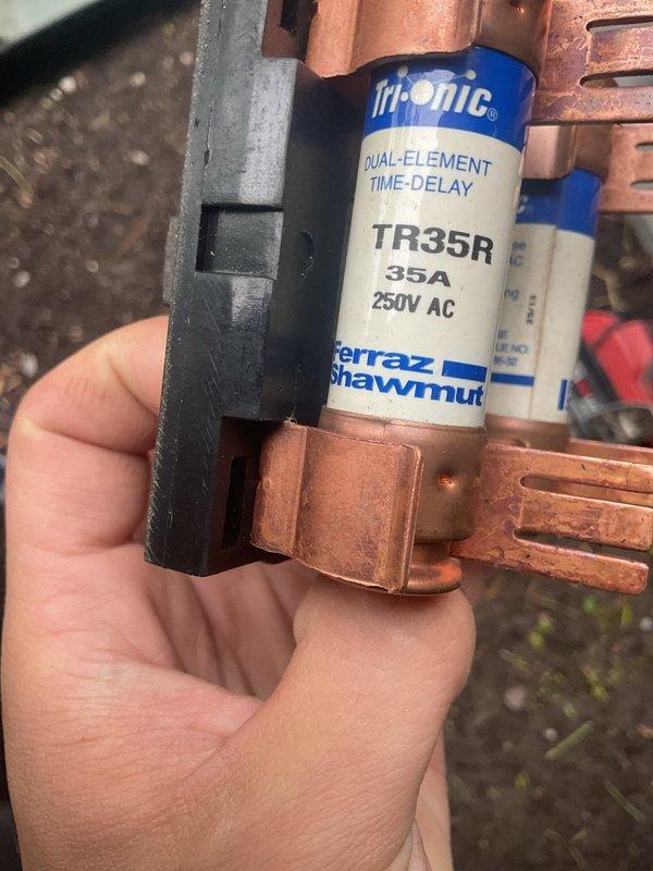 Completed MVP cooling maintenance visit. Inspected and tested electrical components including dual-element time-delay fuses (Tri-onic TR35R, 35A, 250V) mounted on copper bus bars, noting oxidation present on connections. Performed system diagnostics using digital measuring instruments to verify operational parameters and system performance.