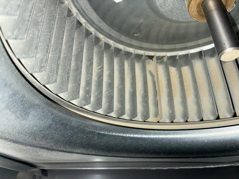 Completed preventive maintenance on residential air conditioning system. Inspected and photographed blower wheel assembly, confirming proper operation with normal dust accumulation on squirrel cage blades. Verified outdoor condenser unit condition, checked mounting stability on concrete pad, and confirmed adequate clearances from structure and landscaping for proper airflow.