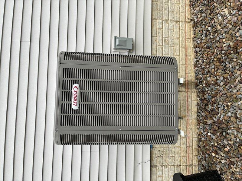 Completed preventive maintenance on residential air conditioning system. Inspected and photographed blower wheel assembly, confirming proper operation with normal dust accumulation on squirrel cage blades. Verified outdoor condenser unit condition, checked mounting stability on concrete pad, and confirmed adequate clearances from structure and landscaping for proper airflow.