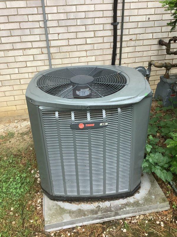 Responded to cooling complaint on approximately 10-12 year old Trane air conditioning unit. Upon arrival, confirmed condenser fan motor was not operating. Inspected outdoor unit and verified compressor was attempting to run but fan remained inoperative. Diagnosed failed condenser fan motor. Replaced defective fan motor with OEM equivalent replacement part. Tested system operation and verified proper airflow through condenser coil. Unit now cooling effectively with all components functioning as designed.