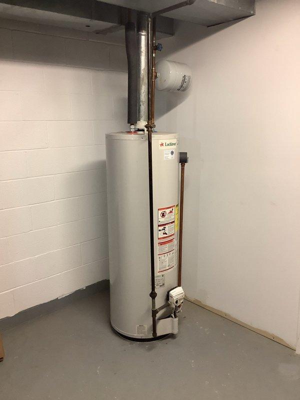 Completed replacement of existing 50-gallon gas water heater with new Lochinvar unit. Installed water heater in basement utility area with proper venting through existing galvanized ductwork and metallic flue pipe. Connected copper supply lines and ensured all safety valves, drain valves, and electrical connections were properly installed and secured according to manufacturer specifications and local code requirements.