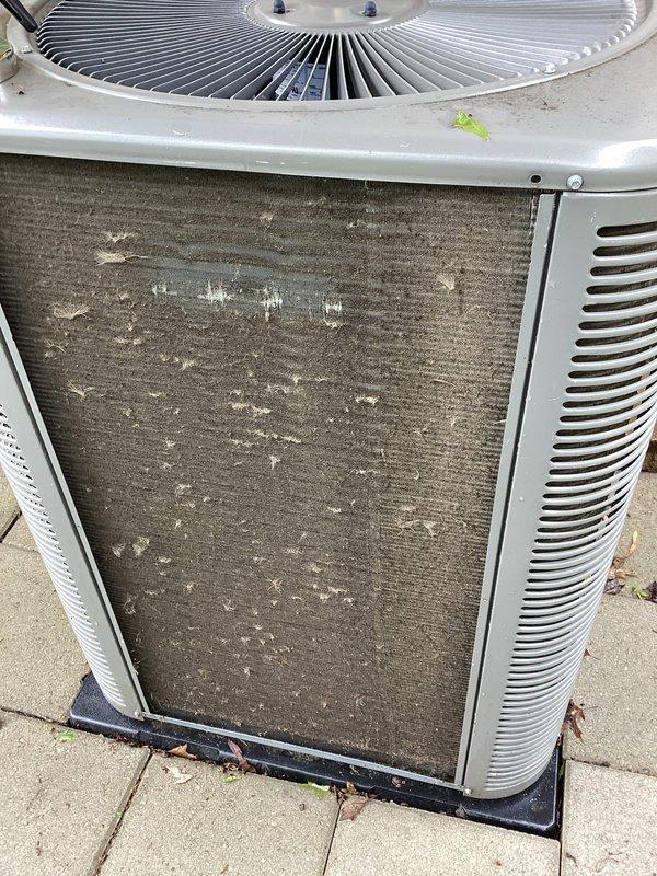 Completed MVP air conditioning maintenance service on outdoor condensing unit. Upon arrival, found condenser coils heavily soiled with significant dirt, dust, and debris accumulation causing restricted airflow. Cleaned condenser coils, replaced air filter, and verified system operation with supply air temperature reading of 69.5°F. Unit returned to proper operating condition with improved airflow and cooling efficiency.