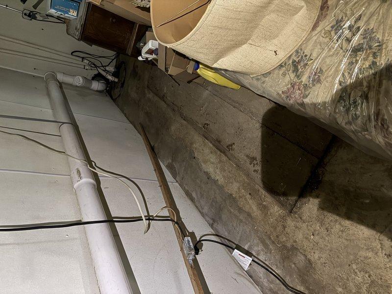 Installed dedicated electrical circuit for septic system in crawl space area. Routed new wiring along existing infrastructure, securing cables to wooden support beams and utilizing proper fastening methods throughout the run. Circuit installation completed to code specifications for septic system operation.