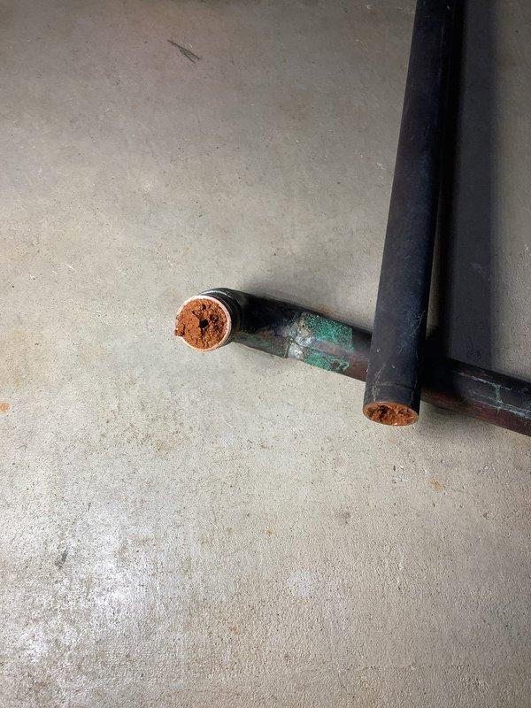 Removed and replaced corroded copper piping section running from the pressure tank to the water softener. Eliminated the existing whole home filter from the system during the repipe. Installed new boiler drain and valve to complete the plumbing repair. Work addressed severe copper corrosion issues that were compromising system integrity and water flow.
