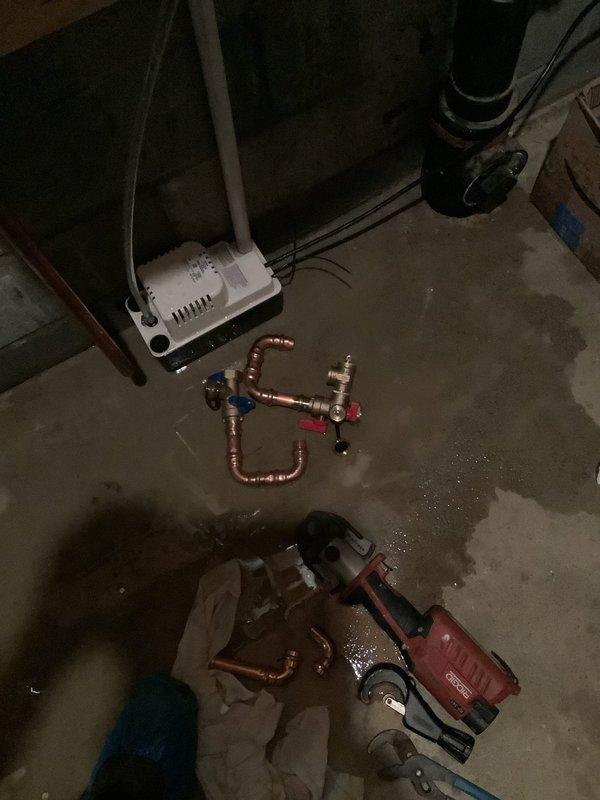 Responded to complaint of tankless water heater leaking 10-15 gallons per day. Installed new temperature and pressure relief valve along with new pressure reducing valve on the water supply system. Copper piping manifold was assembled and configured with appropriate shut-off valves and pressure monitoring equipment, mounted on plywood backing adjacent to the tankless unit. Work completed in approximately 2 hours with all necessary parts ordered and delivered to shop prior to installation.