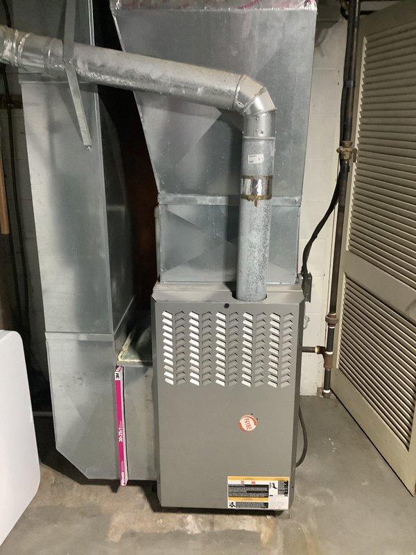 Provided comprehensive HVAC system replacement estimate for residential property, evaluating existing furnace unit installed in mechanical room with standard galvanized ductwork configuration and outdoor condensing unit positioned on asphalt pad against exterior wall. Assessment included documentation of current system condition, noting weathered outdoor unit with surface discoloration and aging components, and indoor furnace with proper ventilation and condensate drainage setup. Prepared detailed replacement options for complete heating and cooling system upgrade to improve efficiency and reliability.