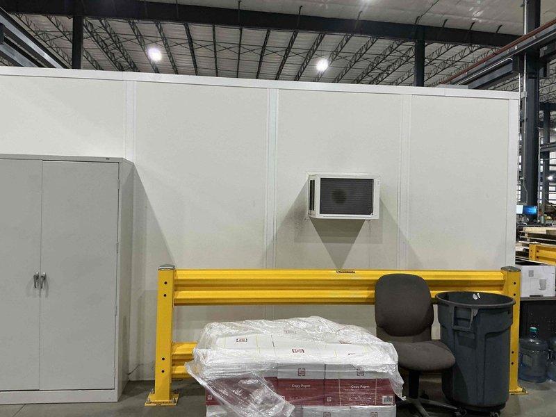 Completed estimate for mini-split installation in interior warehouse office space with modular white wall construction. Customer requested indoor placement of compressor unit in addition to standard air handler installation to accommodate facility layout and operational requirements.